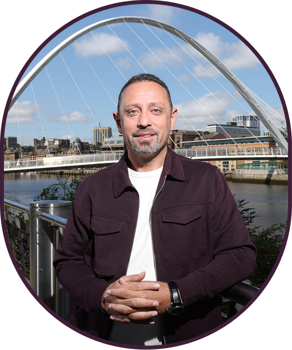 Torch founder standing in front of a river and bridge.